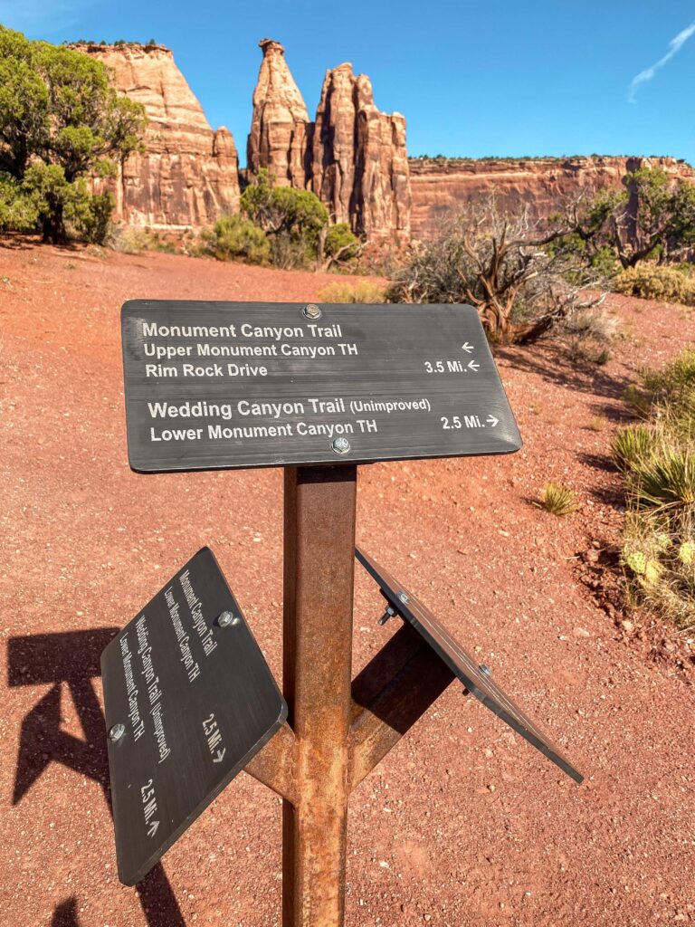 Hiking trail sign for Monument Canyon Trail and Wedding Canyon Trail in Colorado National Monument.