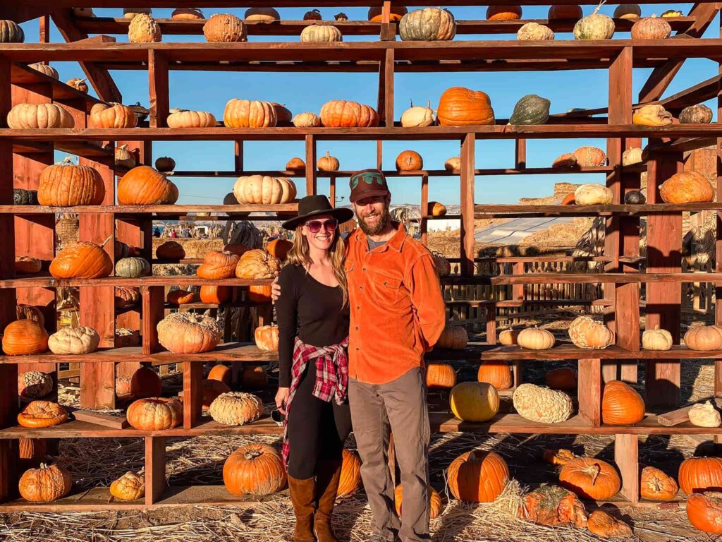 Couple in front of a pumpkin house at Studt Farm in Grand Junction.