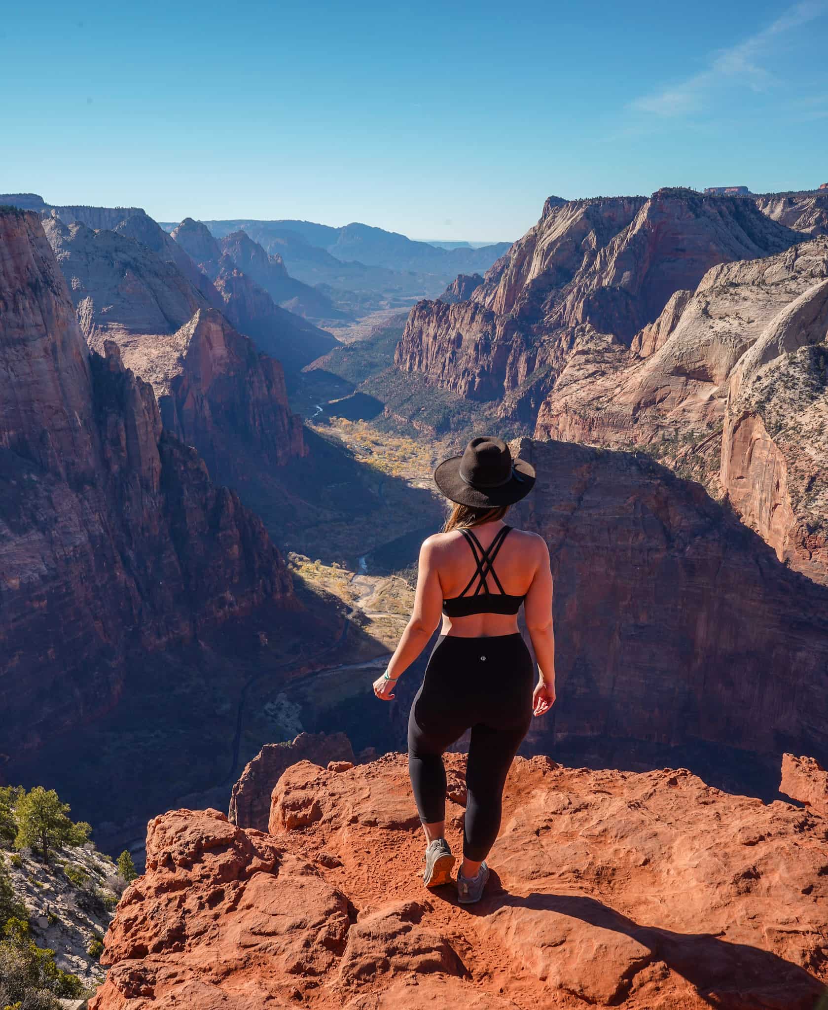 Woman overlooking Zion Canyon while hiking in Southern Utah.