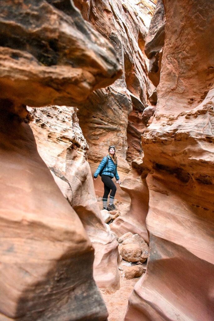 Woman hiking in a slot canyon in Southern Utah.