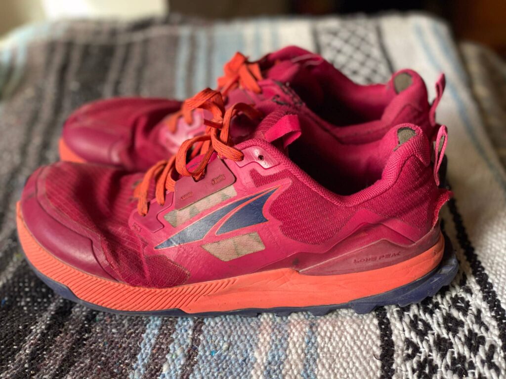 A pair of hot pink Altra Lone Peak 7 trail runners.