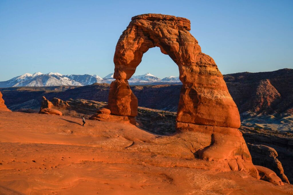 Delicate Arch in Arches National Park with the La Sal mountains behind it