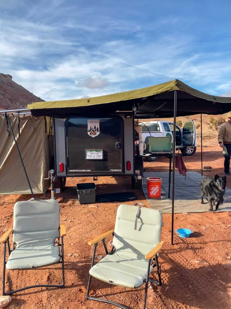 A campsite with a trailer and dog near Hanksville, Utah.
