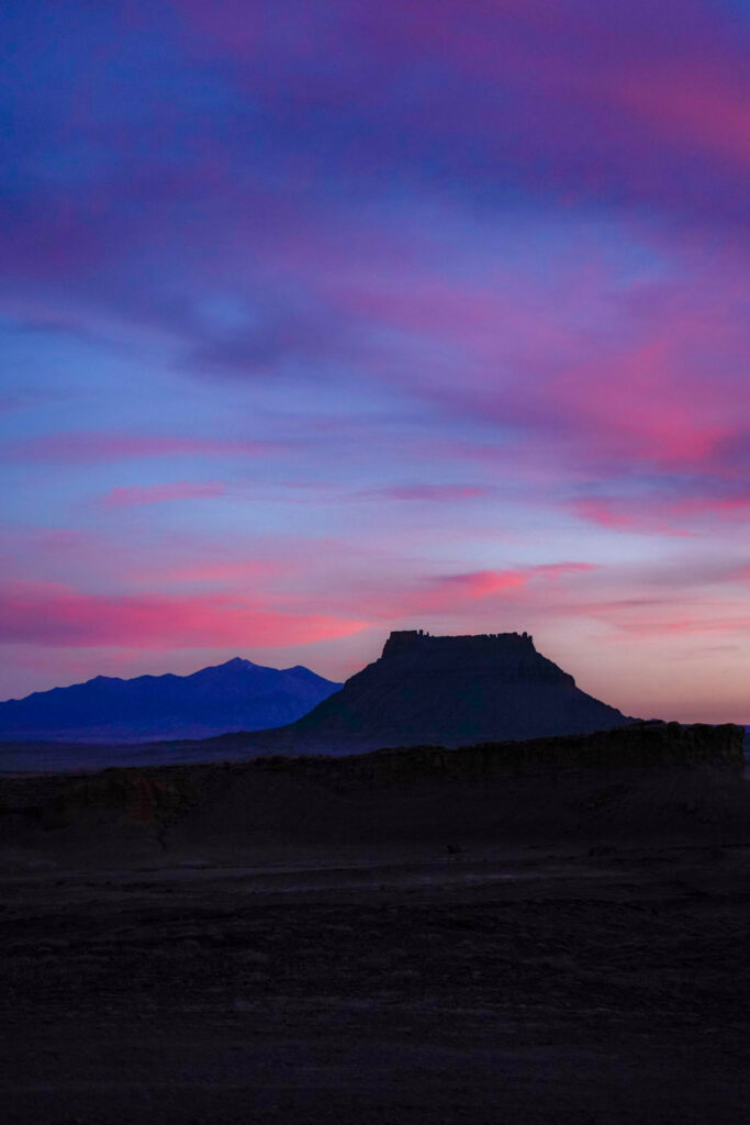 Pink sunset in front of Factory Butte and the Henry Mountains in Southern Utah near Hanksville.