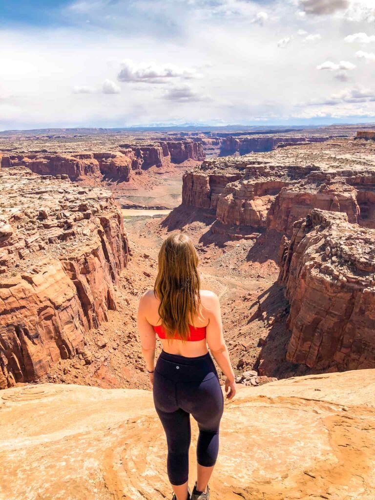 A woman overlooks the Green River and Utah's canyon country near Hanksville.