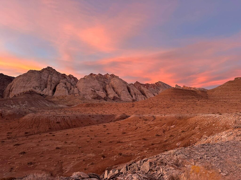 Pink sunset overlooking a rock reef in the San Rafael Swell in Utah.